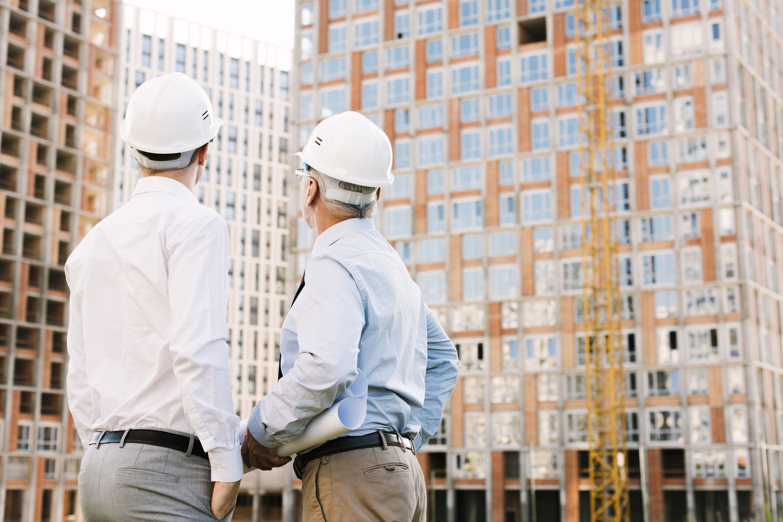 back-view-men-with-white-helmets-suits